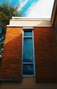 A tall brick building with a skylight above it